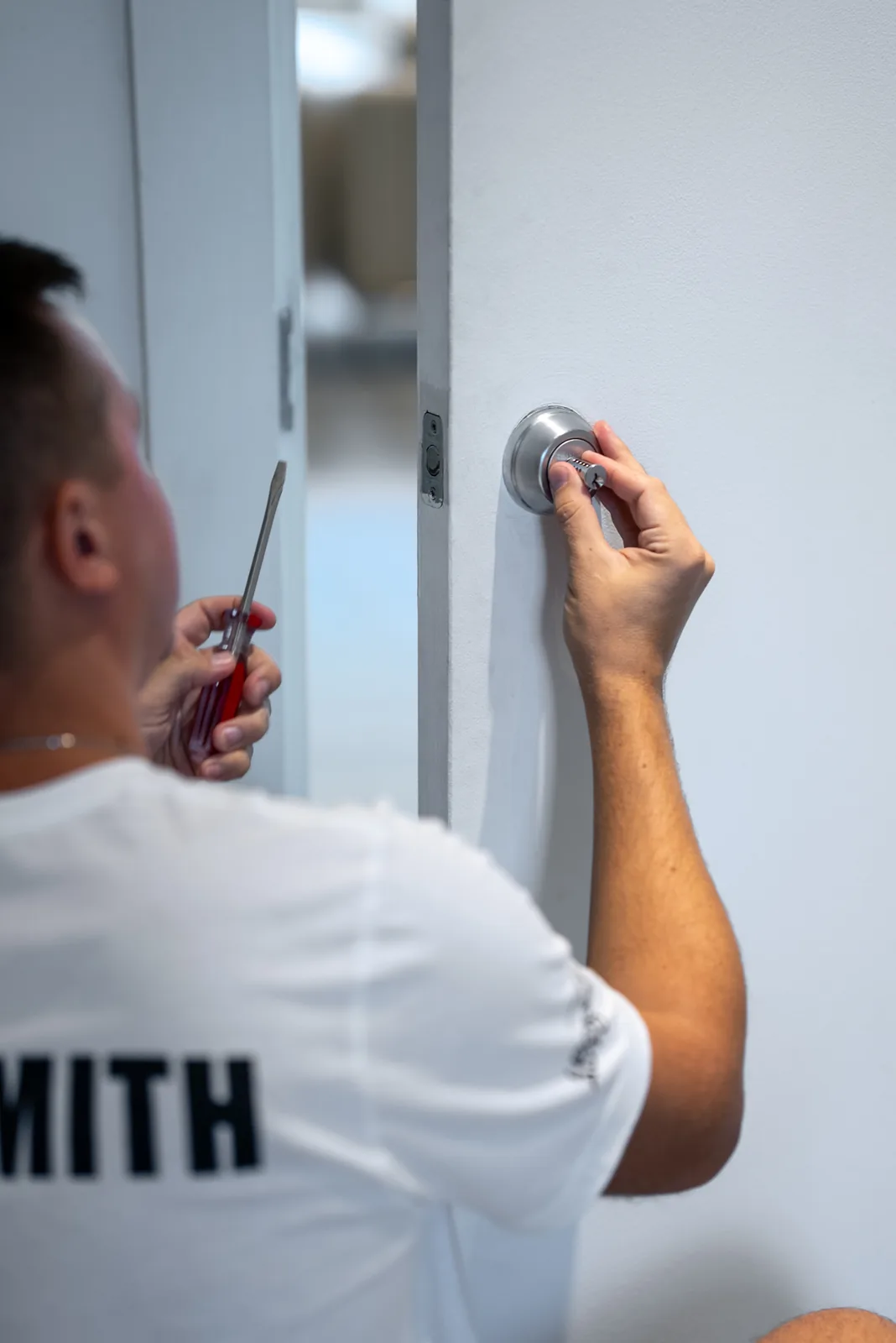 Locksmith Auto technician repairing a deadbolt