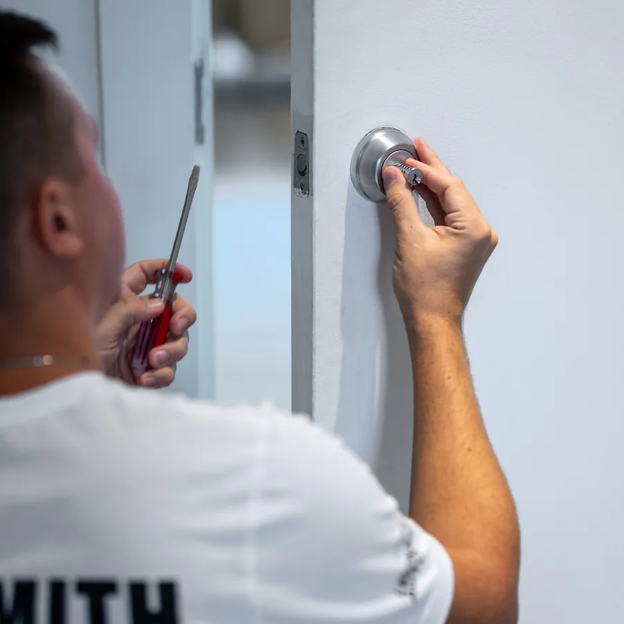 Locksmith Auto technician rekeying a deadbolt