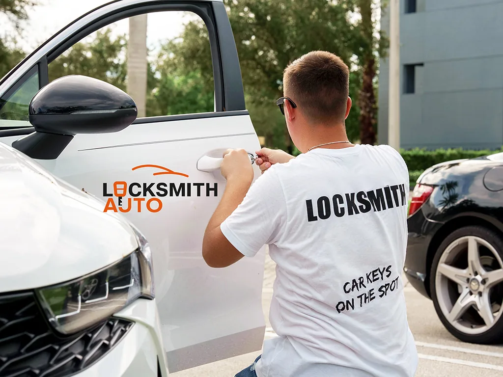 Locksmith Auto technician opening a car door