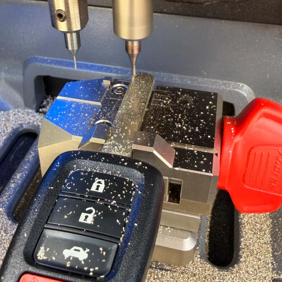 Key cutting machine cutting a new key blade